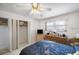 Bright bedroom featuring a ceiling fan, closet, and entertainment area with a TV at 5925 Shore S Blvd # 602, Gulfport, FL 33707