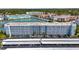 Exterior of building with parking lot and covered parking and view of other community buildings in the background at 5925 Shore S Blvd # 602, Gulfport, FL 33707