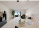 Bright living room with neutral carpet, a decorative fireplace, and sliding doors to a balcony at 5925 Shore S Blvd # 602, Gulfport, FL 33707