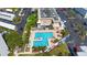 Aerial view of community pool area featuring a pool, lounge chairs, and palm trees at 5925 Shore S Blvd # 602, Gulfport, FL 33707