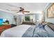 Inviting bedroom with a ceiling fan, large windows, and a comfortable bed at 611 Bannockburn Ave, Temple Terrace, FL 33617