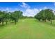 Picturesque golf course view features lush green fairways and manicured landscapes under a bright sky at 611 Bannockburn Ave, Temple Terrace, FL 33617