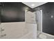Bathroom featuring a bathtub, walk-in shower with glass door, and dark accent wall at 6233 Olivedale Dr, Riverview, FL 33578