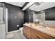 Updated bathroom featuring dual vanities, a glass shower, and modern finishes, offering a luxurious feel at 6233 Olivedale Dr, Riverview, FL 33578