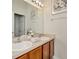 Bathroom with double vanity and chrome faucets under a large mirror framed by wall sconces at 6233 Olivedale Dr, Riverview, FL 33578