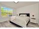 Bright bedroom with a large window, neutral walls, and plush bedding, creating a relaxing atmosphere at 6233 Olivedale Dr, Riverview, FL 33578