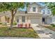 Charming two-story home featuring an attached garage and landscaped front yard at 6233 Olivedale Dr, Riverview, FL 33578