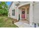 Charming home exterior showcasing a welcoming front door and well-maintained landscaping at 6233 Olivedale Dr, Riverview, FL 33578
