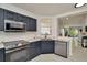 Modern kitchen with navy cabinets and stainless steel appliances at 6233 Olivedale Dr, Riverview, FL 33578