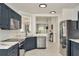 Modern kitchen with stainless steel appliances, dark blue cabinets, and marble countertops at 6233 Olivedale Dr, Riverview, FL 33578