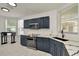 Modern kitchen features dark blue cabinets, stainless steel appliances, and granite countertops at 6233 Olivedale Dr, Riverview, FL 33578