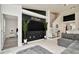Open-concept living room featuring sleek white tile, a stylish black accent wall, and modern decor at 6233 Olivedale Dr, Riverview, FL 33578