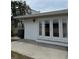 Backyard features a covered patio with access to the home through french doors at 627 E Davis Blvd, Tampa, FL 33606