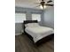 Bedroom with a queen bed, wood-look flooring, and a ceiling fan at 627 E Davis Blvd, Tampa, FL 33606