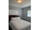 Cozy bedroom featuring a queen bed, neutral colors, and window with blinds at 627 E Davis Blvd, Tampa, FL 33606