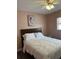 Comfortable bedroom with a queen size bed, fan, and art piece at 627 E Davis Blvd, Tampa, FL 33606