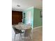 Open-concept dining area with seating for four, featuring marble table and modern decor at 627 E Davis Blvd, Tampa, FL 33606