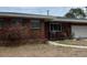 Close-up of a charming single-story brick home with an attached garage and walkway at 627 E Davis Blvd, Tampa, FL 33606