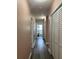 Hallway with wood-look flooring, leading to the bathroom and bedrooms at 627 E Davis Blvd, Tampa, FL 33606