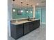 Modern kitchen with bar seating and granite countertops at 627 E Davis Blvd, Tampa, FL 33606