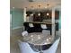 A modern, eat-in kitchen featuring an island with bar stool seating, gray cabinets, and stainless appliances at 627 E Davis Blvd, Tampa, FL 33606