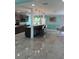 A modern, eat-in kitchen featuring an island with bar stool seating, gray cabinets, and stainless appliances at 627 E Davis Blvd, Tampa, FL 33606