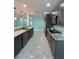 A modern kitchen featuring gray cabinets, stainless appliances, and granite countertops at 627 E Davis Blvd, Tampa, FL 33606