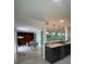 Open-concept kitchen and dining area with granite countertops, pendant lighting, and ample space at 627 E Davis Blvd, Tampa, FL 33606