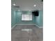 Bright living room with large window and contemporary decor featuring sleek tile floors at 627 E Davis Blvd, Tampa, FL 33606