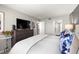 Bedroom with a dresser and large tv and an entrance to a bathroom at 6295 Bahia Del Mar Cir # 406, St Petersburg, FL 33715