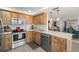 Kitchen with wooden cabinets, stainless appliances, and modern pendant lighting at 6295 Bahia Del Mar Cir # 406, St Petersburg, FL 33715
