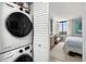 This condo includes a stacked washer and dryer, as well as a peek at the bright and airy main bedroom at 6295 Bahia Del Mar Cir # 406, St Petersburg, FL 33715