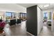 Open-concept living room with wood floors, stylish furnishings, and expansive windows offering scenic views at 6295 Bahia Del Mar Cir # 406, St Petersburg, FL 33715
