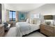 The spacious main bedroom boasts a comfortable bed, water view, and stylish furnishings at 6295 Bahia Del Mar Cir # 406, St Petersburg, FL 33715