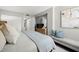 This primary suite has luxury bed, dresser, round mirror, and an attached laundry area at 6295 Bahia Del Mar Cir # 406, St Petersburg, FL 33715