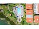 Overhead shot showcases a pristine pool surrounded by beautiful landscaping, blue umbrellas at 6295 Bahia Del Mar Cir # 406, St Petersburg, FL 33715