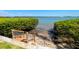Private water access with a wooden staircase leading to the bay, surrounded by lush greenery at 6295 Bahia Del Mar Cir # 406, St Petersburg, FL 33715