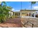 Backyard view, featuring a swing, patio area, and the exterior of the home with ample natural light at 6415 13Th N Ave, St Petersburg, FL 33710