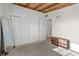 Bedroom showcasing carpeted floors, exposed beam ceiling, built in storage and a dresser at 6415 13Th N Ave, St Petersburg, FL 33710