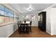 Bright breakfast area featuring light-filled windows, hardwood floors, and a black china cabinet at 6415 13Th N Ave, St Petersburg, FL 33710