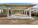 View of large carport with white pillars attached to a single-story home with the house number displayed at 6415 13Th N Ave, St Petersburg, FL 33710