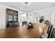 Bright dining area featuring hardwood floors, a large table, and a dark wood china cabinet for ample storage at 6415 13Th N Ave, St Petersburg, FL 33710
