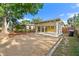 Charming single-story home with a carport, gravel parking, and mature trees in the front yard at 6415 13Th N Ave, St Petersburg, FL 33710