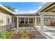 Cozy front porch with seating area, accessible entrance, and meticulously landscaped surroundings at 6415 13Th N Ave, St Petersburg, FL 33710