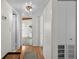 Bright hallway with hardwood floors and white walls and trim leading to multiple rooms at 6415 13Th N Ave, St Petersburg, FL 33710