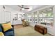 Inviting living room with built-in bookshelves, hardwood floors, and large windows with backyard views at 6415 13Th N Ave, St Petersburg, FL 33710