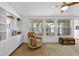 Inviting living room featuring built-in bookshelves, hardwood floors, and oversized windows at 6415 13Th N Ave, St Petersburg, FL 33710