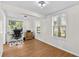 Well-lit home office with vinyl floors, a modern desk setup and views of the outdoors at 6415 13Th N Ave, St Petersburg, FL 33710