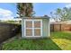 Backyard shed providing extra storage space, surrounded by a green lawn at 6415 13Th N Ave, St Petersburg, FL 33710