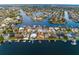Waterfront community featuring a canal system with boats docked behind stunning homes with backyard pools at 6442 Lake Sunrise Dr, Apollo Beach, FL 33572